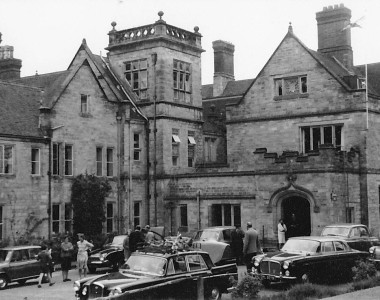 Mr Lang , with his back to the photographer, Mrs Lang by the front door