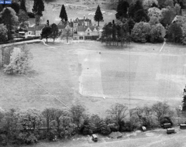 Main school building with sports field in foreground and lower terrace with Newells rough at top of picture