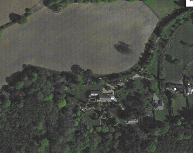 Newells is in the centre of the picture with the drive, as it was, circling up to the right. The buildings furthest right are the old Stable block. There is a new bungalow in what was the kitchen garden. Across the light brown area, which were the playing fields, you can still see the remains of the swimming pool.