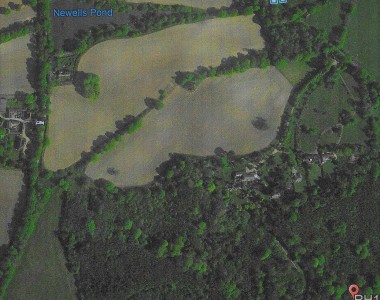 A broader landscape than the previous picture. You can see Newells pond clearly marked. The Scrase-Dickens Newells farm to the left and below the pond. The drive going down to the house from the Horsham road. The main path can be seen ( lower right ) that used to run across the front of the school and end at the farm.